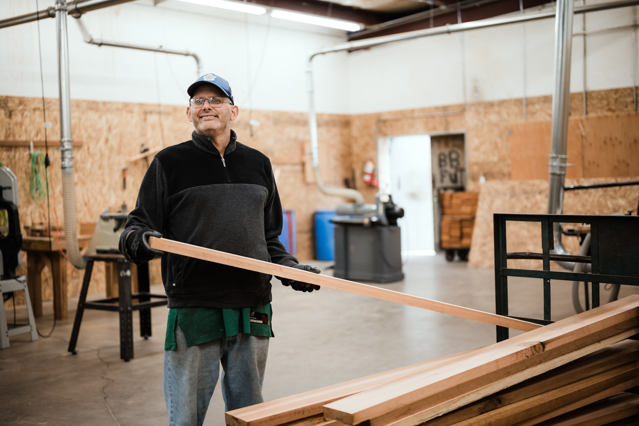 Person working with wooden slats Person working with wooden slats